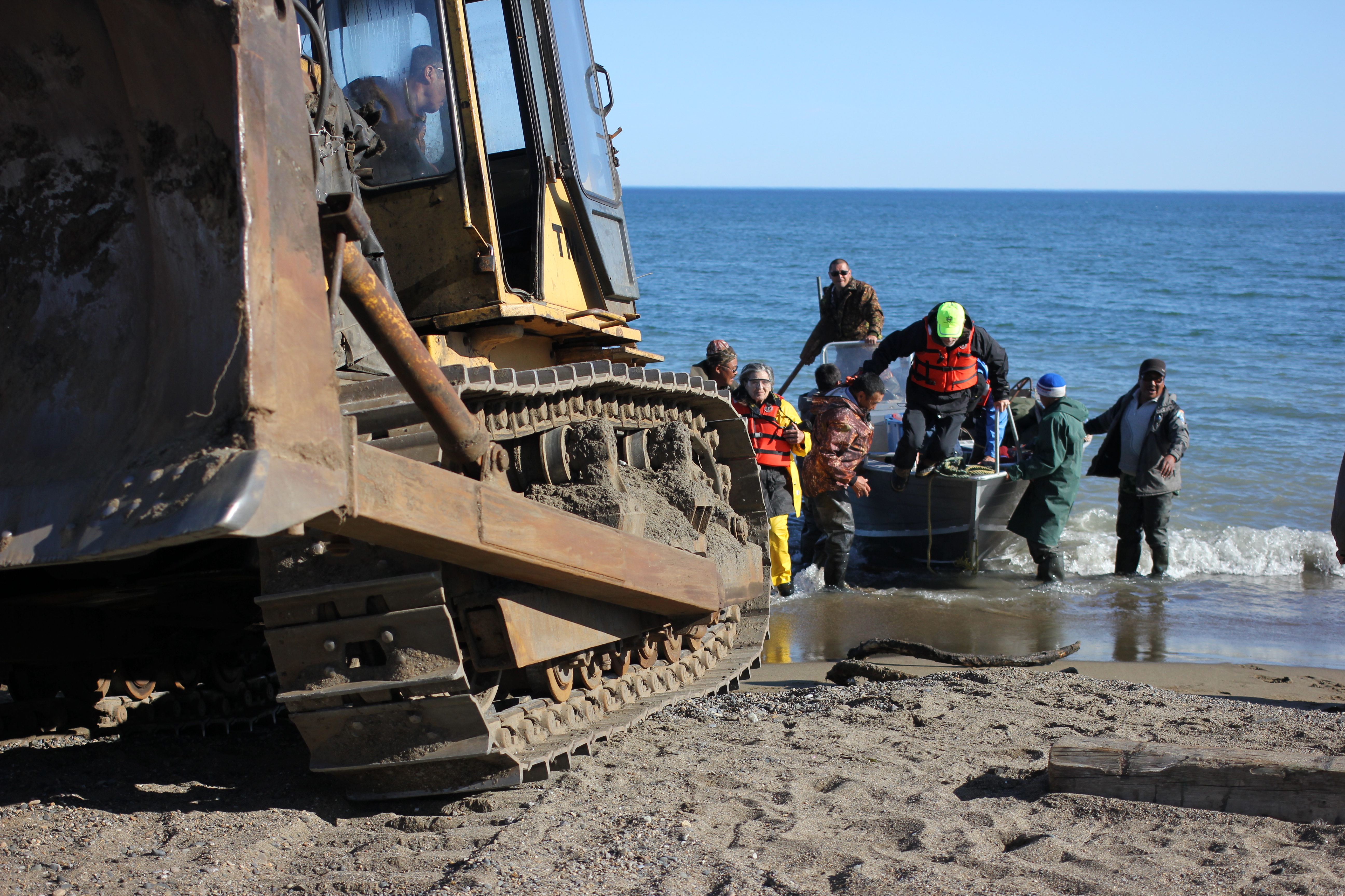 Travelers with the Diomede Island Family Reunion expedition disembark in Lorino, Chukotka in early July 2016. There are no docks, and boats are pulled ashore using a combination of manpower, heavy machinery and whalebone skids. (Kirsten Swann / Alaska Dispatch News)