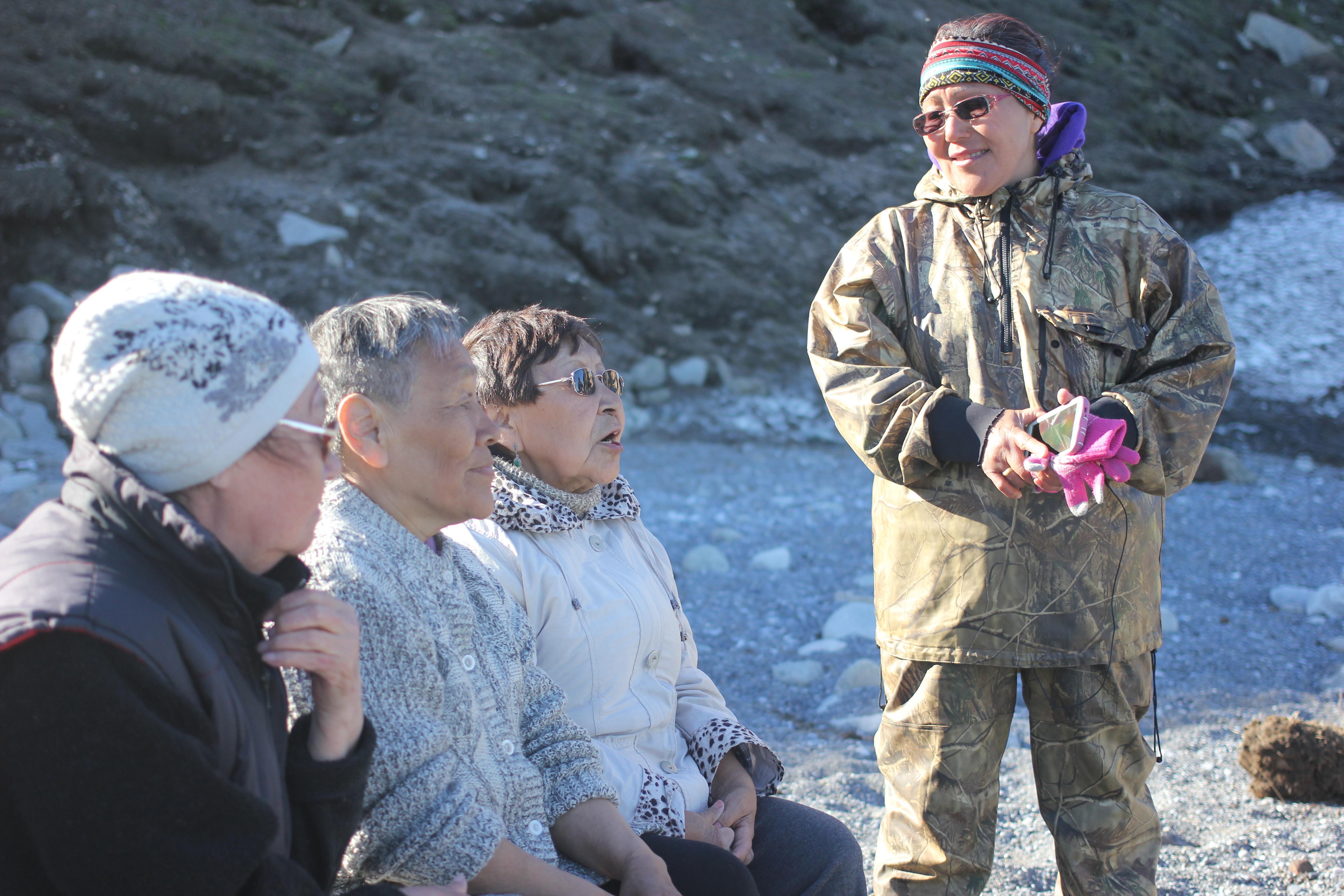 Etta Tall speaks with elders from Lavrentiya, Chukotka, during a visit to the abandoned settlement of Naukan, July 2016. Most Big Diomede residents were relocated to Naukan in 1948 -- Naukan itself was closed in 1958. (Kirsten Swann / Alaska Dispatch News)