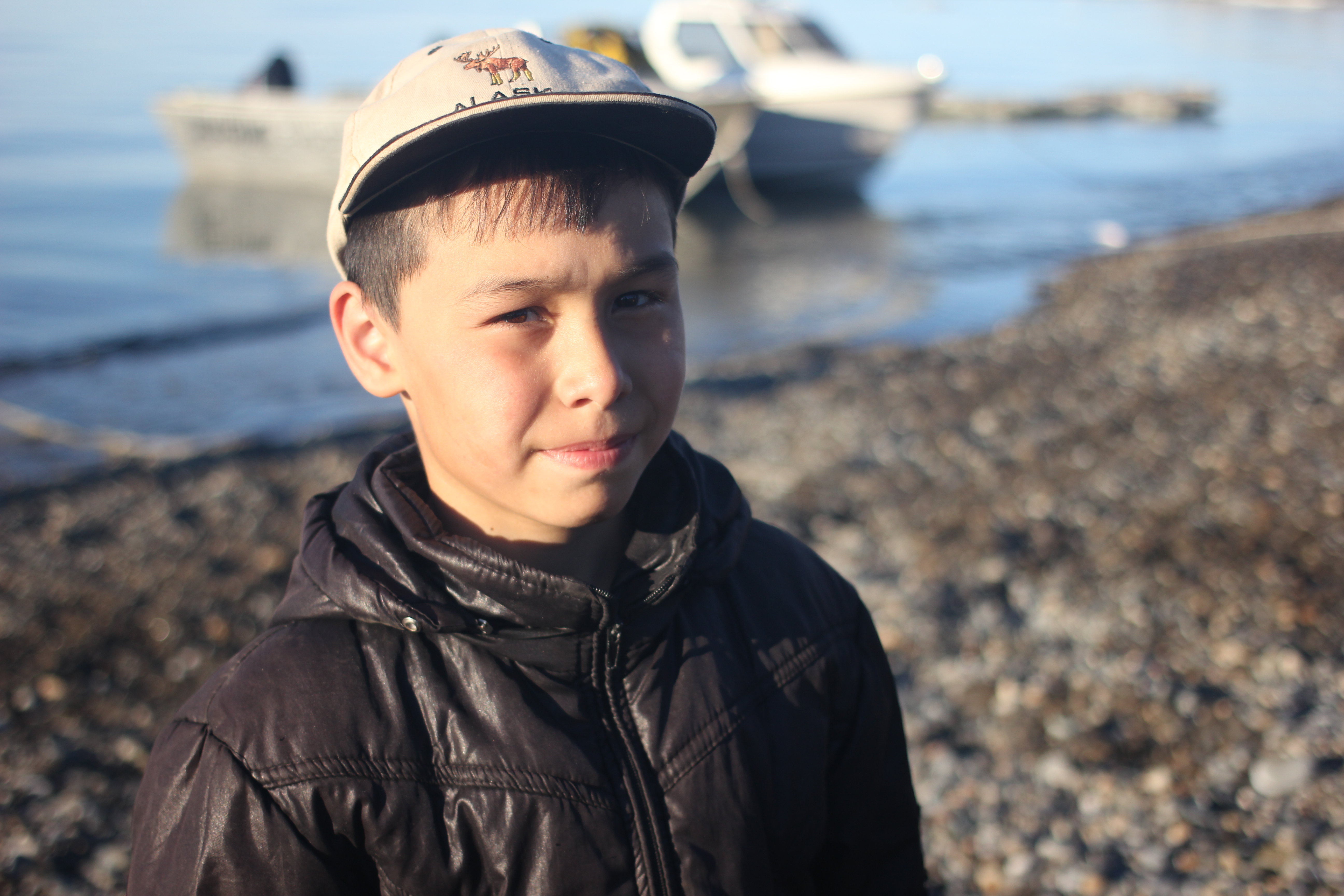 A young member of local dance group wears a cap from Alaska on the beach at Uelen, Chukotka, July 2016. This far north, international travel is rare, but Uelen’s dance group has flown to Alaska to perform. (Kirsten Swann / Alaska Dispatch News)