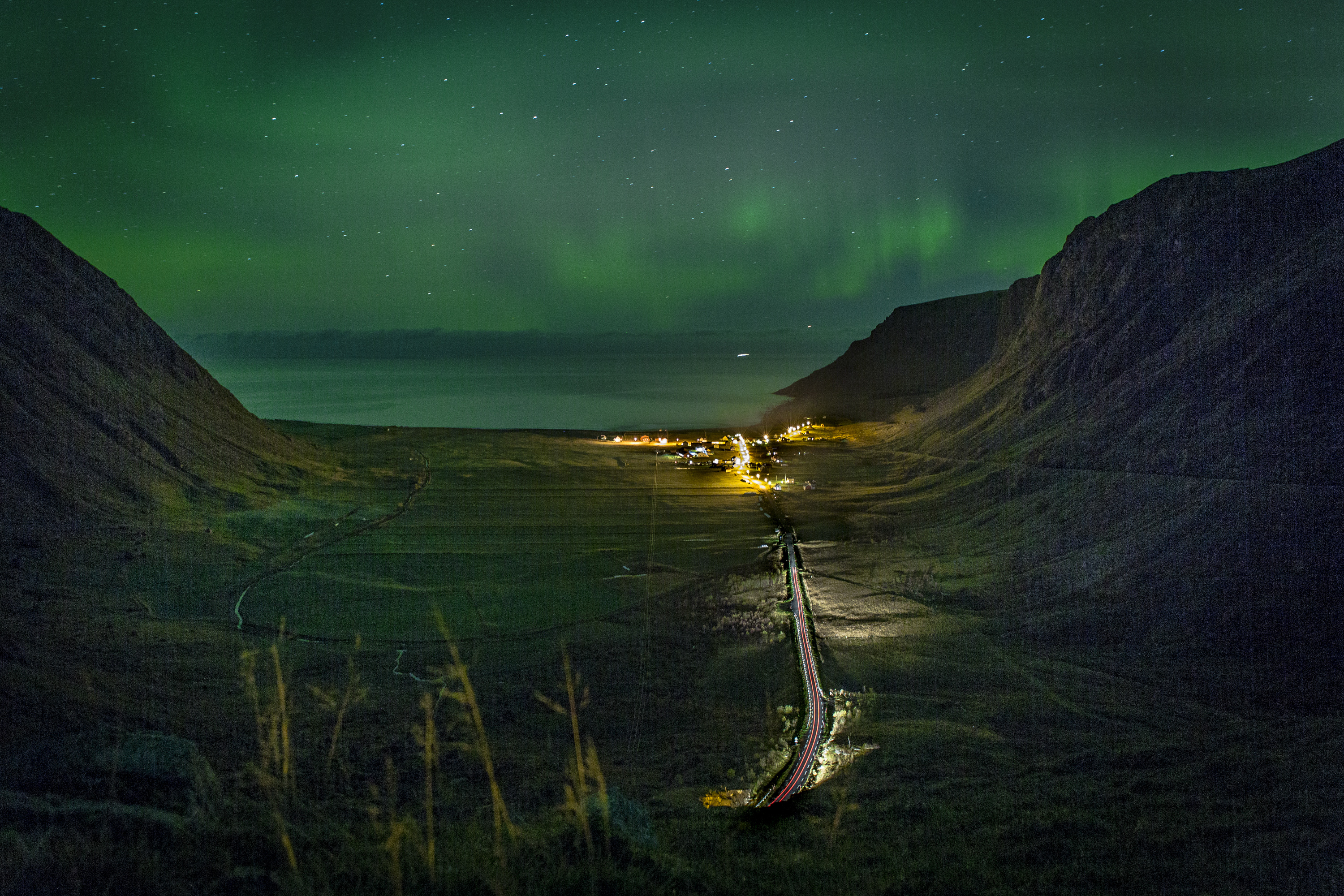The Northern Lights color the sky over the Norwegian Sea in Unstad, Norway, a remote town between two mountains in the Lofoten Islands, Oct. 8, 2016. The Lofoten Masters surfing competition, 6,000 miles North of Hawaii and above the Arctic Circle, is billed as the world's northernmost. ÒEveryone has done the tropics,Ó says Swedish surfer Timothy Latte. ÒCold water surfing is the new black.Ó (Leslye Davis/The New York Times)