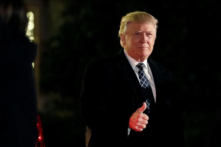 U.S. President-elect Donald Trump gives a thumbs up to the media as he arrives at a costume party at the home of hedge fund billionaire and campaign donor Robert Mercer in Head of the Harbor, New York, on Dec. 3, 2016. (Mark Kauzlarich / Reuters)