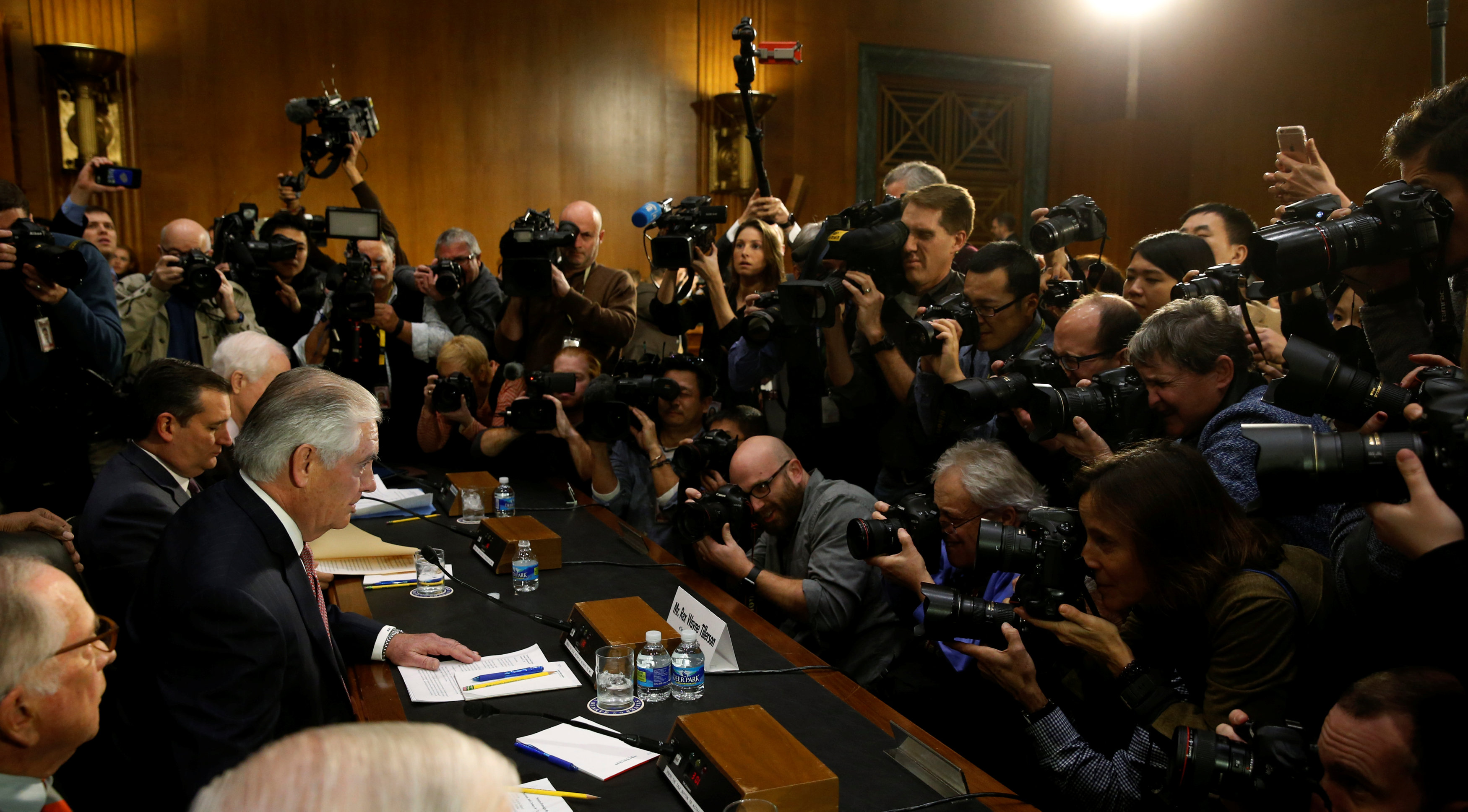 Rex Tillerson (L), the former chairman and chief executive officer of Exxon Mobil, takes his seat to testify before a Senate Foreign Relations Committee confirmation hearing on his nomination to be U.S. secretary of state in Washington, U.S. January 11, 2017.  REUTERS/Jonathan Ernst
