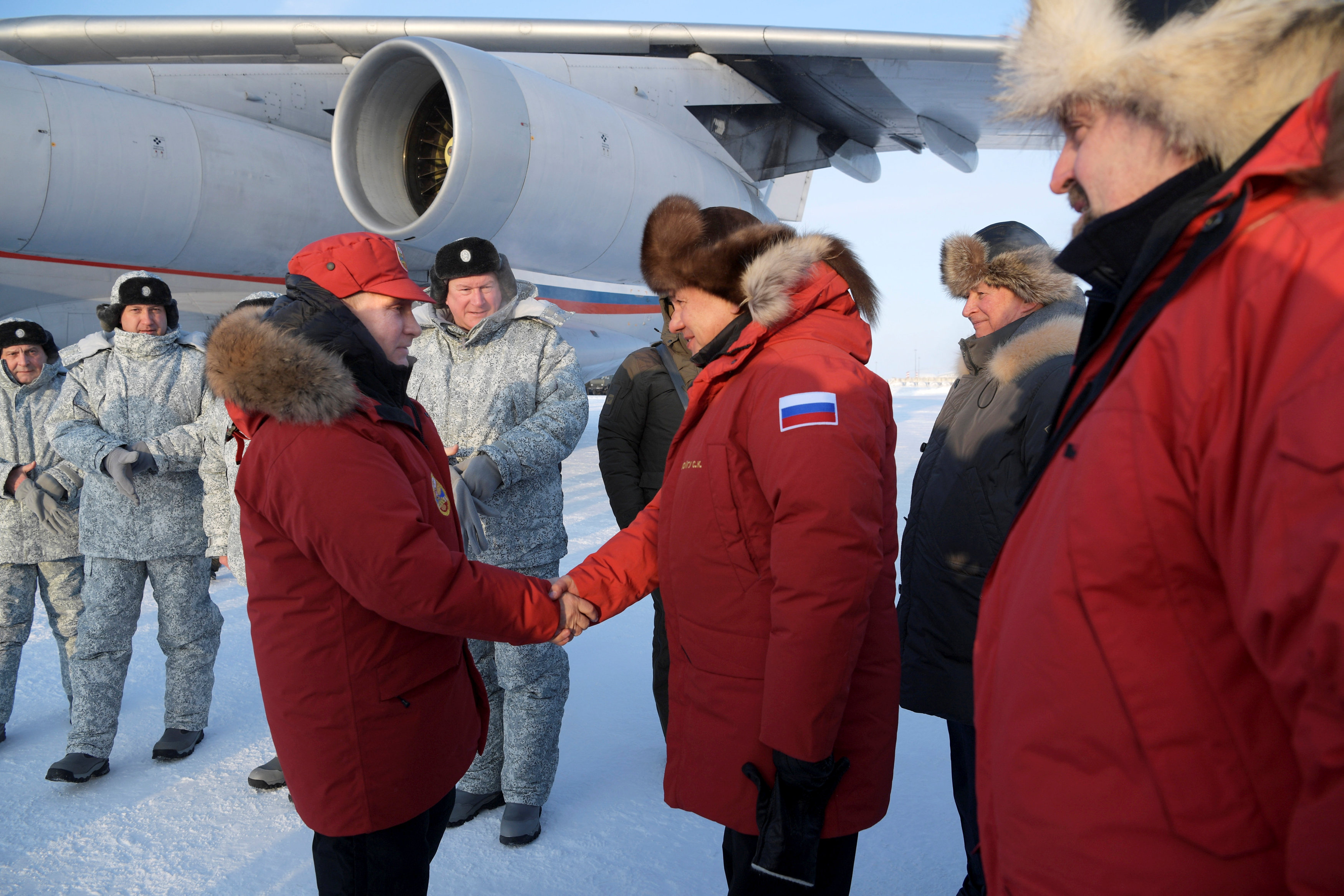 Russian President Vladimir Putin is welcomed by Defence Minister Sergei Shoigu, Natural Resources Minister Sergei Donskoi and Sergei Ivanov, Putin's special representative on questions of ecology and transport, upon his arrival to the remote Arctic islands of Franz Josef Land, Russia March 29, 2017. Sputnik/Alexei Druzhinin/Kremlin via REUTERS
