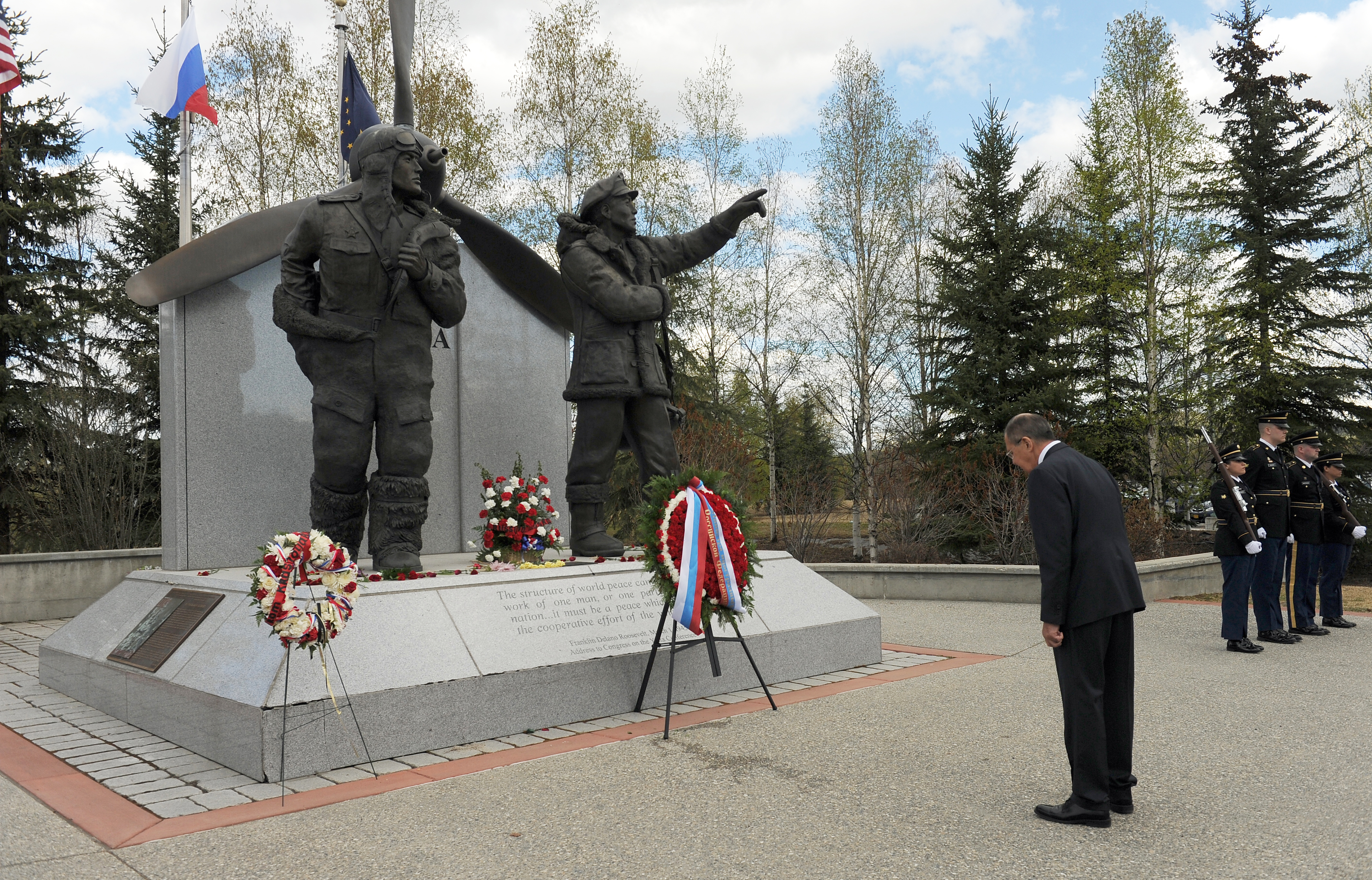 Minister of Foreign Affairs of the Russian Federation, Sergey Lavrov, bows his head during a wreath laying ceremony at the Alaska Siberia Lendlease Memorial in Fairbanks, Alaska, on Thursday, May 11, 2017. The memorial honors the U.S. and Soviet pilots who ferried planes from the U.S. to Siberia during World War II. At right stands the Alaska Army National Guard honor guard. (Bob Hallinen / Alaska Dispatch News)