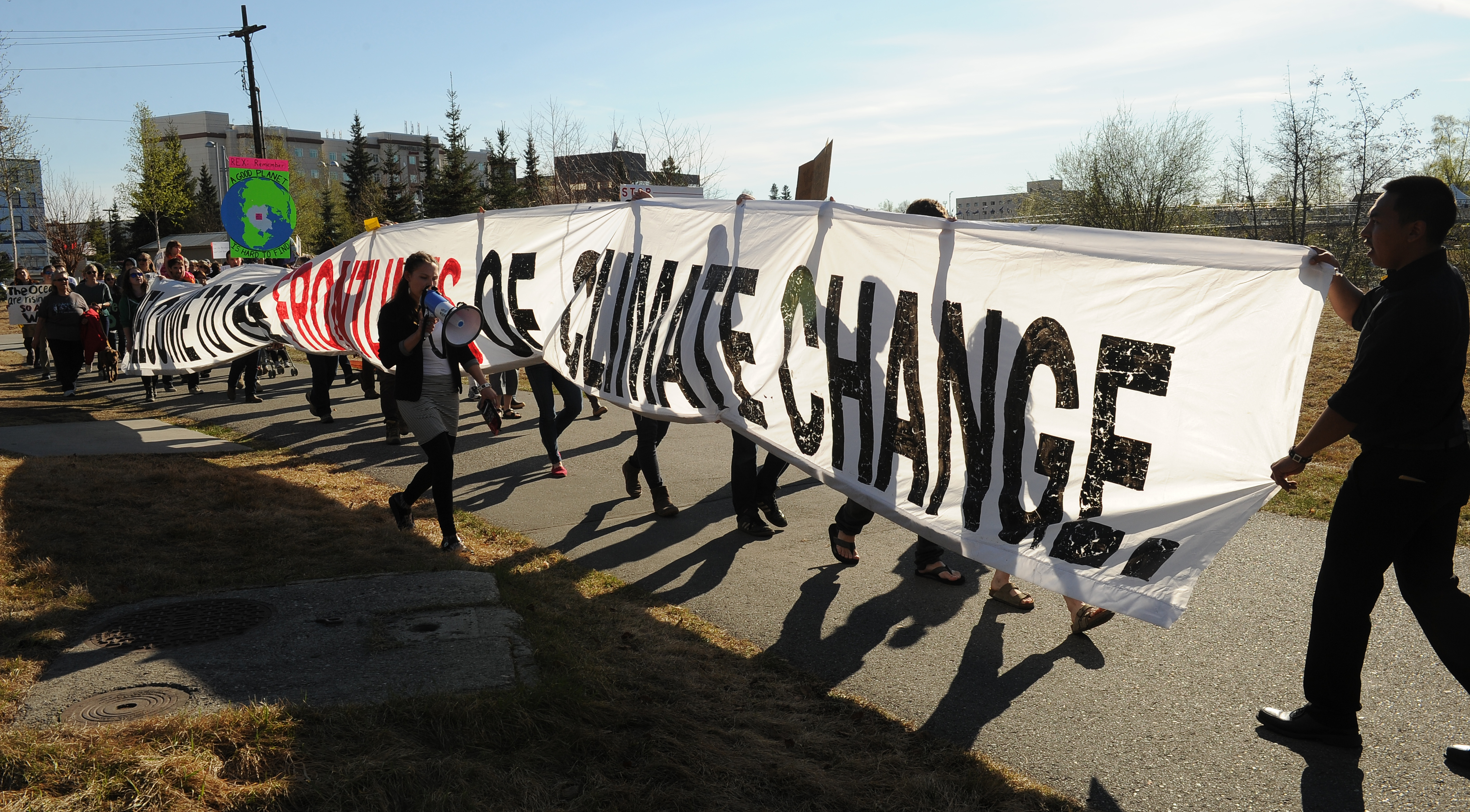 Hundreds of climate change protesters gathered at the Golden Heart Plaza to listen to speakers and then marched around the Morris Thompson Cultural & Visitors Center where Arctic Council attendees were having a reception in downtown Fairbanks, Alaska on Wednesday, May 10, 2017. The protest was organized by Defend the Sacred Alaska a group of Alaska Native and non-native activists from across the state. (Bob Hallinen / Alaska Dispatch News)