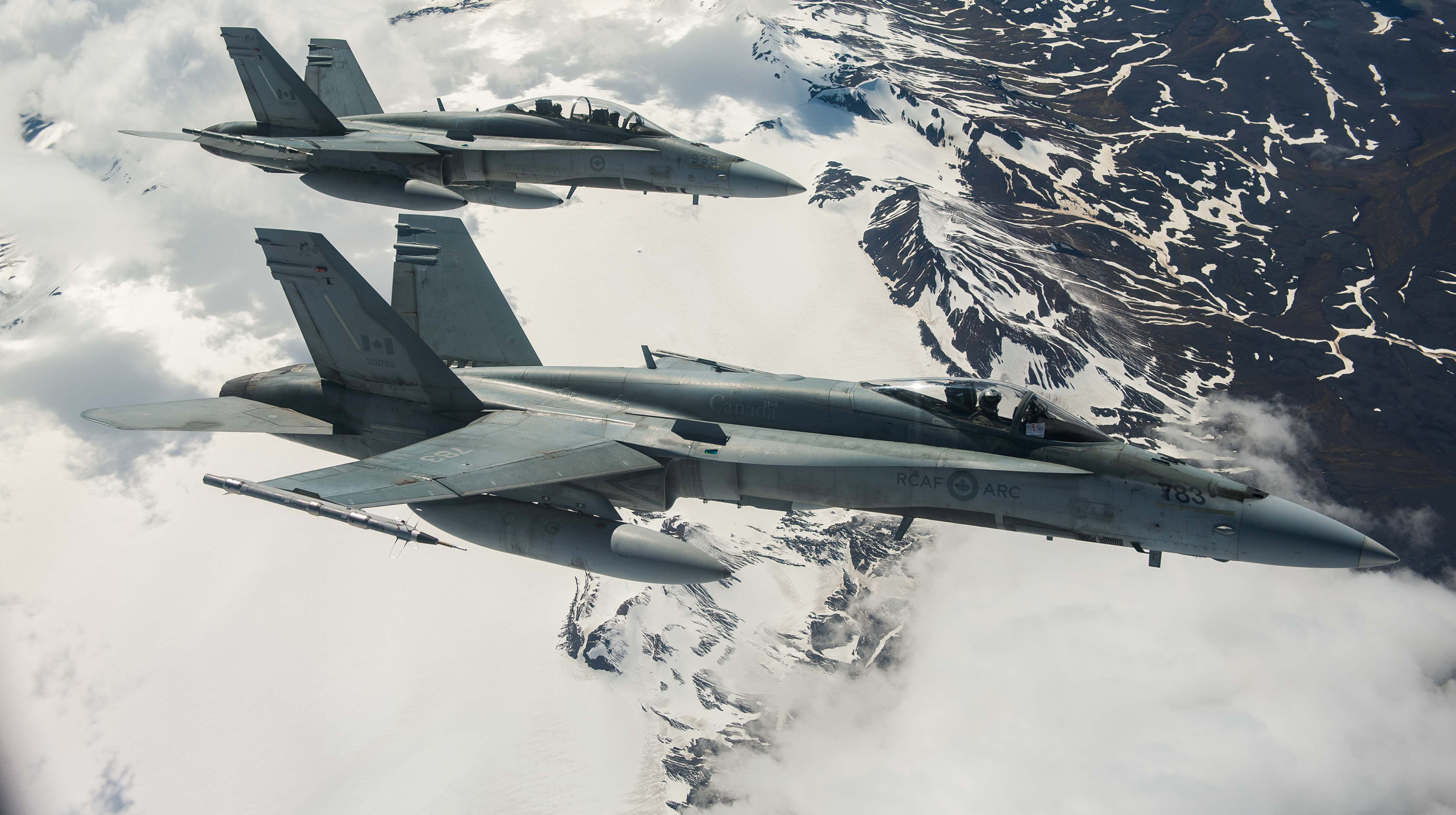 Two Royal Canadian Air Force CF-188 Hornet fighters from 433 Tactical Fighter Squadron fly over Iceland during an Operation REASSURANCE surveillance mission on May 31, 2017.  (Gary Calvé / Courtesy Canadian Armed Forces via Reuters)