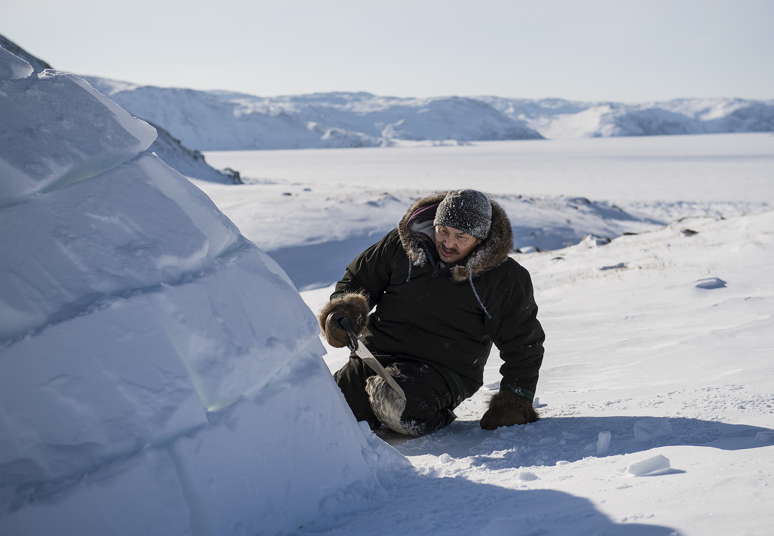 Adami Sakiagak demonstrates how to build an igloo near Kangiqsujuaq, Nunavik, Quebec, Canada, March 2, 2017. Sakiagak, a 57-year-old Inuit, builds igloos to teach younger generations the disappearing craft. (Aaron Vincent Elkaim / The New York Times)