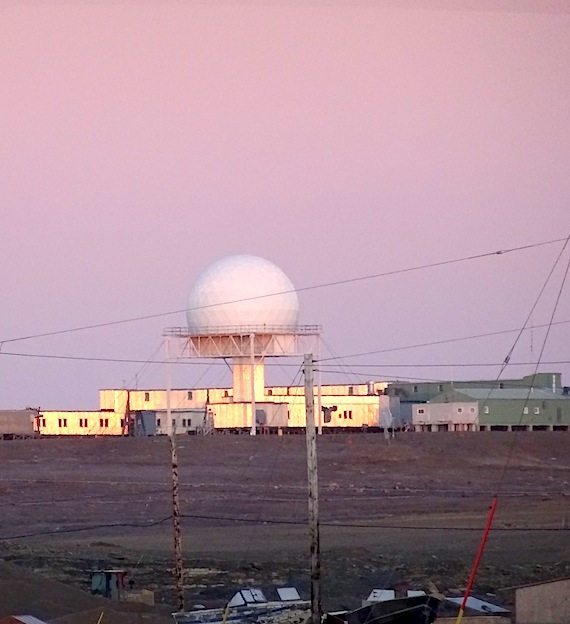 Renovations and expansions could be in store for the big radar bulb of the CamMain North Warning Site in Cambridge Bay, against a pink sky. (Jane George / Nunatsiaq News)