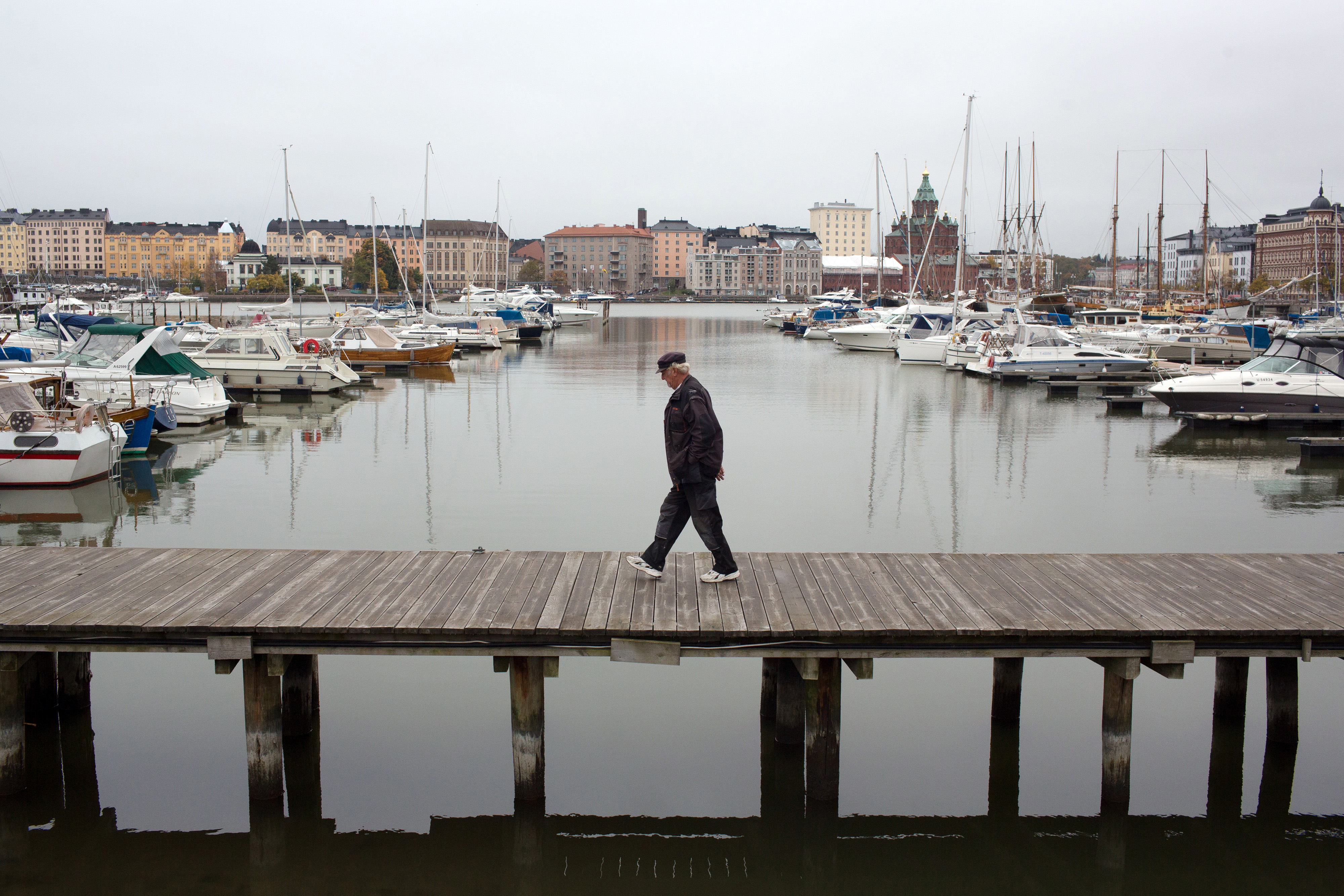 A pedestrian walks along a platform in the south harbor at the port of Helsinki in Helsinki, Finland, on Oct. 13, 2016. MUST (Andrey Rudakov / Bloomberg)