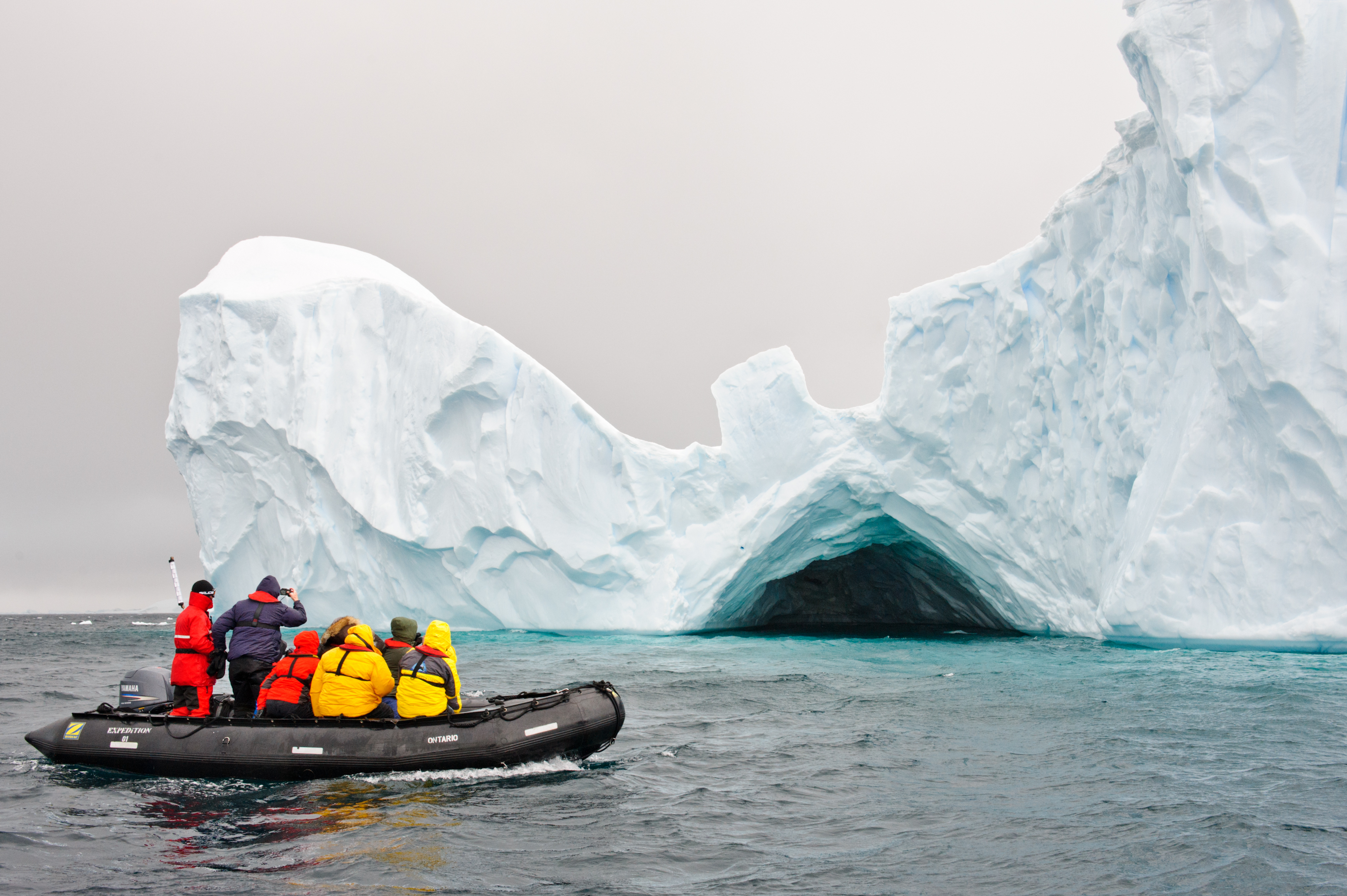 A group of tourists on a tour with Zodiac, floating around iceberg near Neko harbor, Antarctica. (Getty)