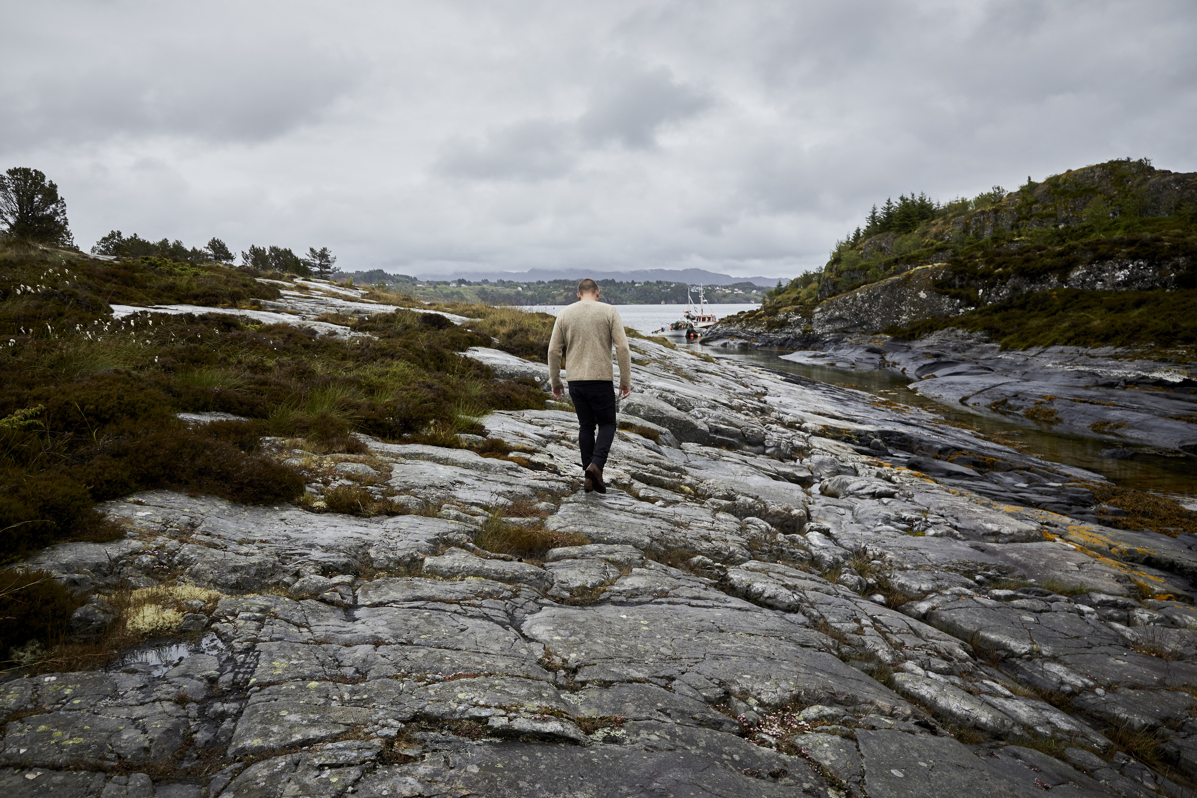 Lyseverket owner and chef Christopher Haatuft, walks across a rocky landscape on Sotra, an island in the North Atlantic just west of Bergen, Norway, July, 2017. New Nordic chefs are guided by solemn manifestoes about nature and culture, and often restrict themselves to Scandinavian ingredients. Haatuft, who is the opposite of solemn, coined a new term for the food at his restaurant: neo-fjordic. (David B. Torch/The New York Times)