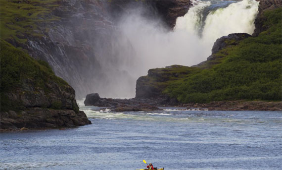 A kayaker visits Nastapoka Falls, just north of Umiujaq. (Sarah Rogers / Nunatsiaq News)