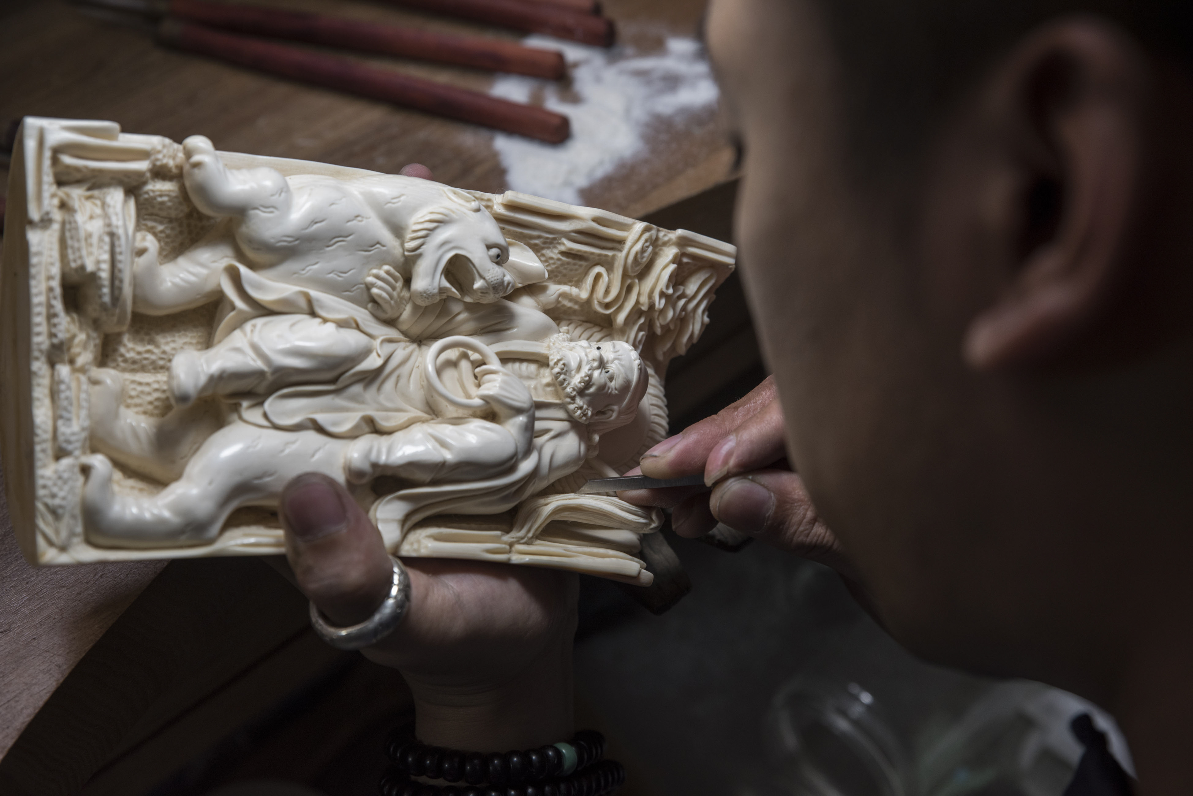 A worker carves mammoth tusks at Jin Sha Mammoth, on the outskirts of Beijing, July 28, 2017. To sustain a carving and collecting tradition that is centuries old, many Chinese artisans have turned to the tusks of extinct mammoths harvested from an unlikely place: the melting permafrost of Russia’s Arctic. (Gilles Sabrie/The New York Times)