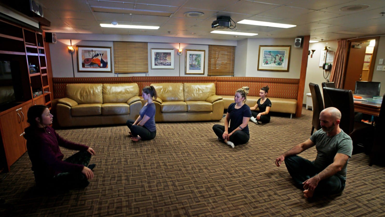 Aude Boivin-Rioux teaches yoga in the officer's lounge. (Alice Li / The Washington Post)