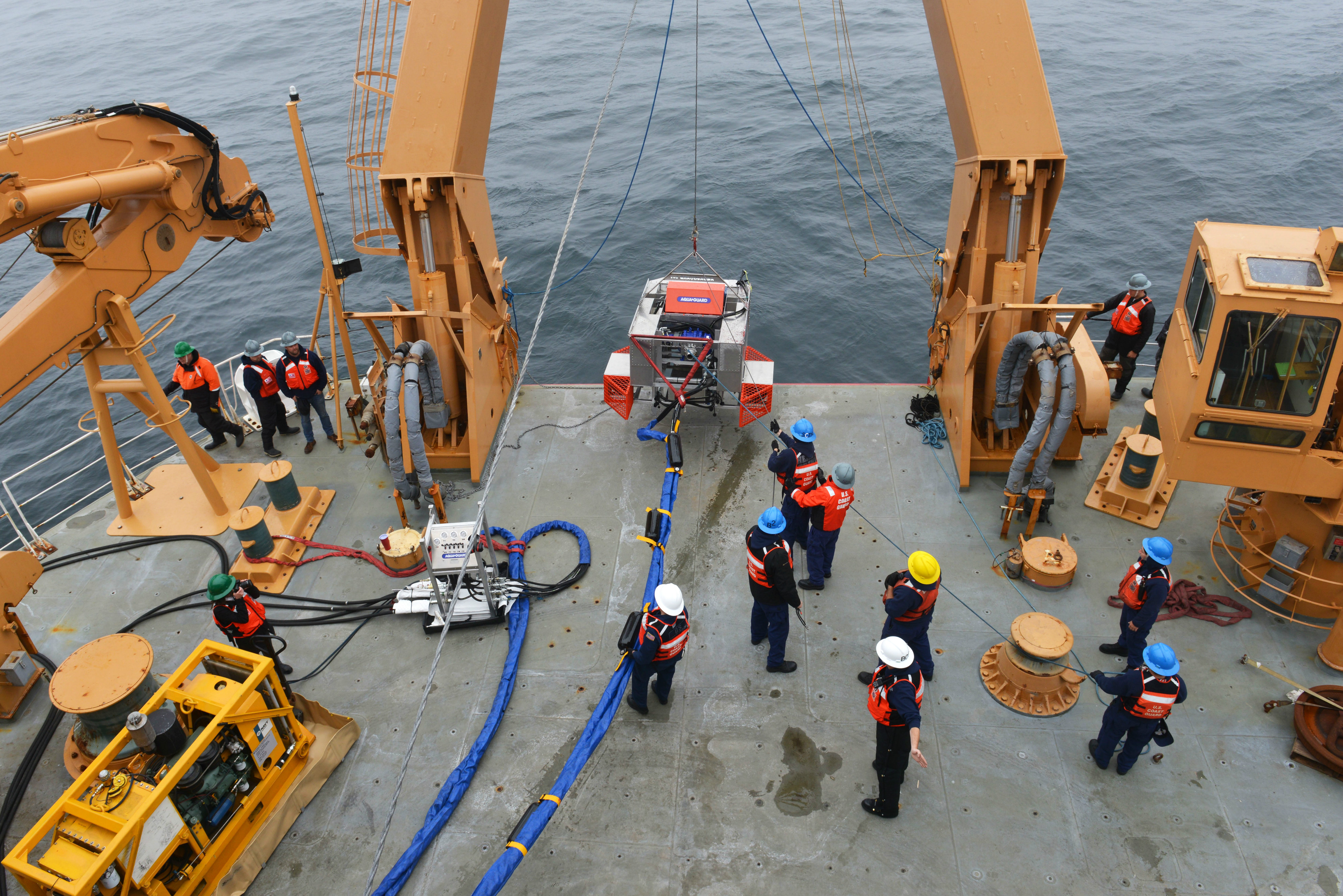 The RotoX oil skimmer is hoisted onto the Coast Guard Cutter Healy after a test in the Bering Sea northwest of St. George in July. (Senior Chief Petty Officer Rachel Polish / U.S. Coast Guard)