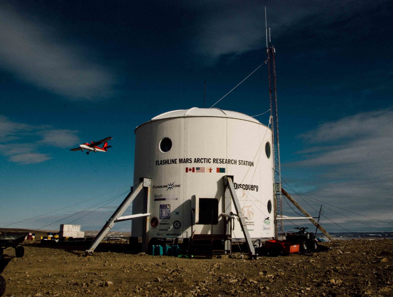 A twin otter aircraft flying over the Flashline Mars Arctic Research Station on Devon Island. (Mars Society)