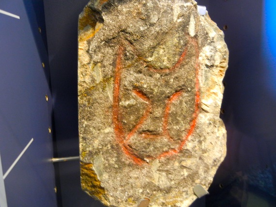 A cat-like face peers from a rock on display at the Pingualuit provincial park's visitors centre in Kangiqsujuaq in 2010. The engraving, collected in the 1960s, hails from the nearby island of Qajartalik. (Jane George / Nunatsiaq News)
