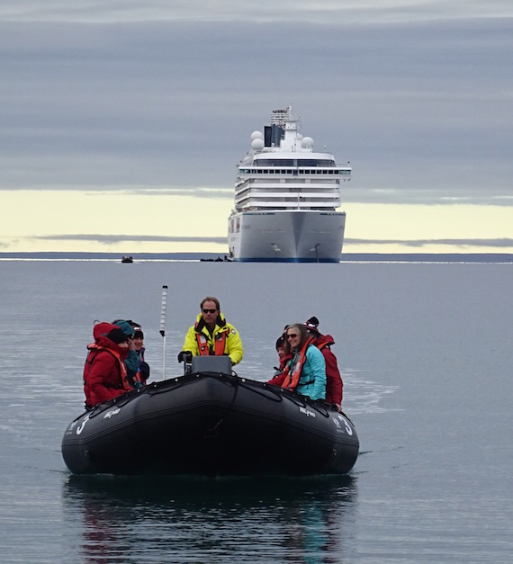 A staff member off the Crystal Serenity brings passengers to shore in Cambridge Bay in August 2016 when the Crystal Serenity cruise ship called in the western Nunavut community. (Jane George / Nunatsiaq News)